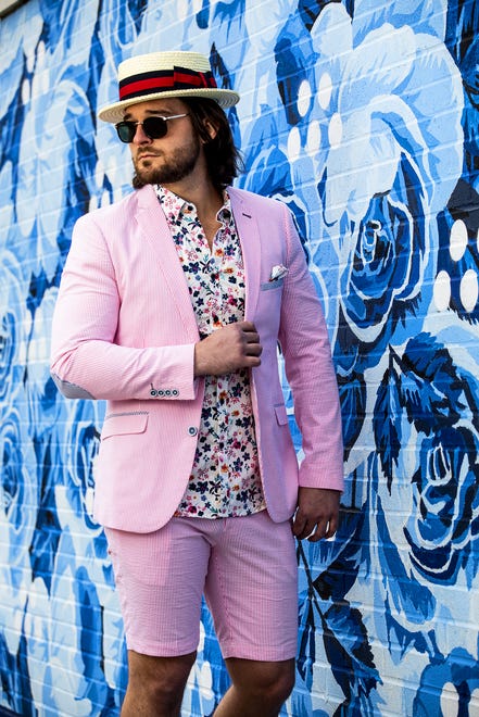 Josh Frank models in a pink seersucker sport coat and shorts; floral seersucker shirt, pocket square, and straw boater during a Kentucky Derby fashion shoot with stylist Jo Ross at Churchill Downs. March 11, 2020