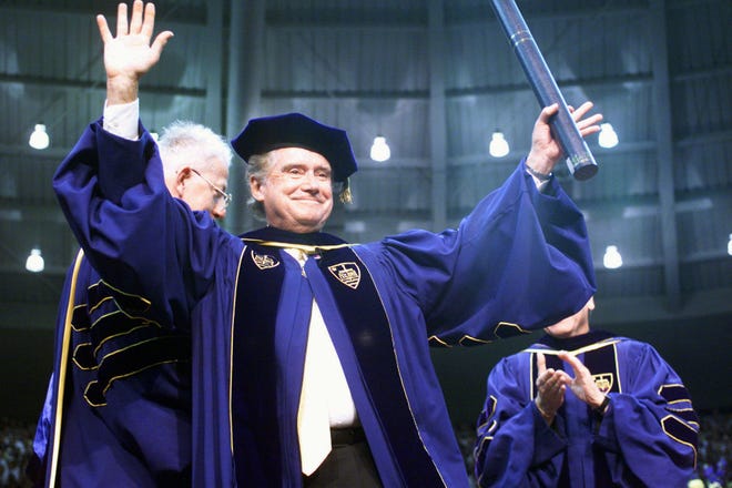Regis Philbin, a Notre Dame graduate, waves to the crowd after receiving an honorary degree during Notre Dame's 154th commencement exercises on May 16, 1999, in South Bend, Indiana.