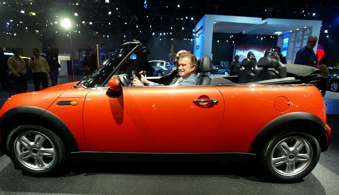 Regis Philbin checks out the new Mini Cooper convertible at a media preview of the New York International Auto Show on April 7, 2004.