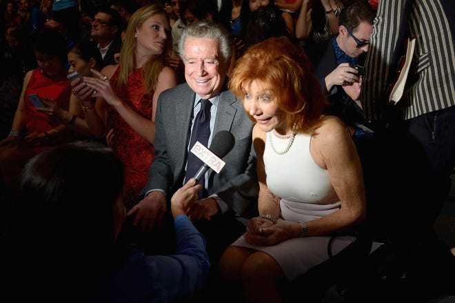 Regis Philbin and Joy Philbin attend the Carmen Marc Valvo Spring 2014 show during Mercedes-Benz Fashion Week on Sept. 6, 2013, in New York.
