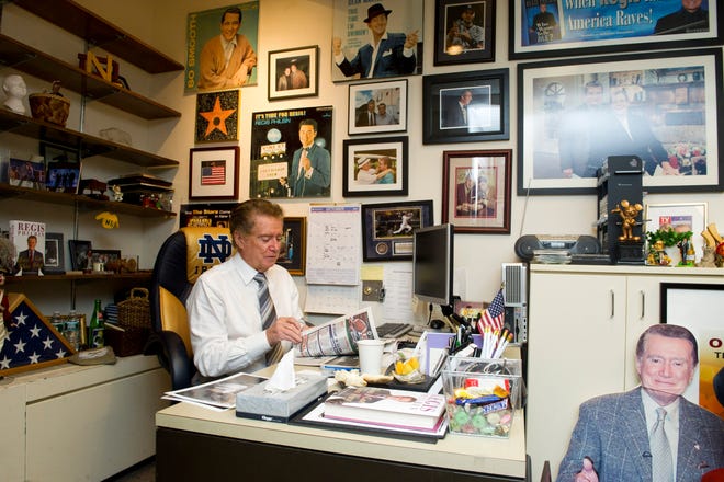 Regis Philbin reads a newspaper in his office before taping an episode of "Live! With Regis and Kelly" in New York on Oct. 28, 2011.