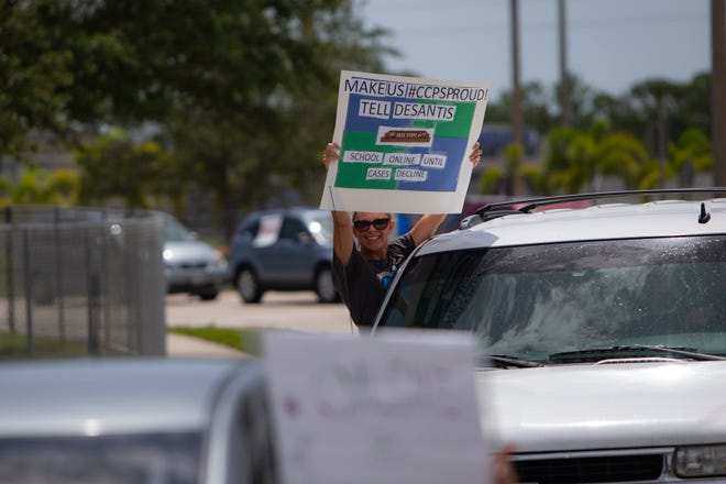 Demonstrators line up along Osceola Trail as they drive toward the  Collier County Public Schools Dr. Martin Luther King, Jr. Administrative Center offices in North Naples on Monday, July 27, 2020. Local educators and community members held a drive-by protest to shed light on their fears in regards to reopening schools this fall.