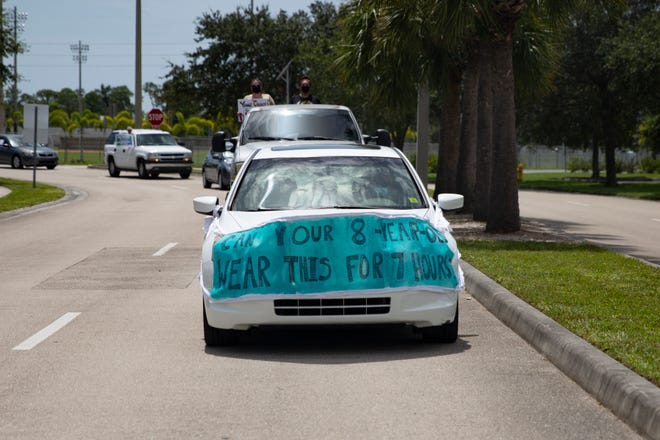 Demonstrators drive past the Collier County Public Schools Dr. Martin Luther King, Jr. Administrative Center offices in North Naples on Monday, July 27, 2020, to shed light on their fears of reopening schools this fall.