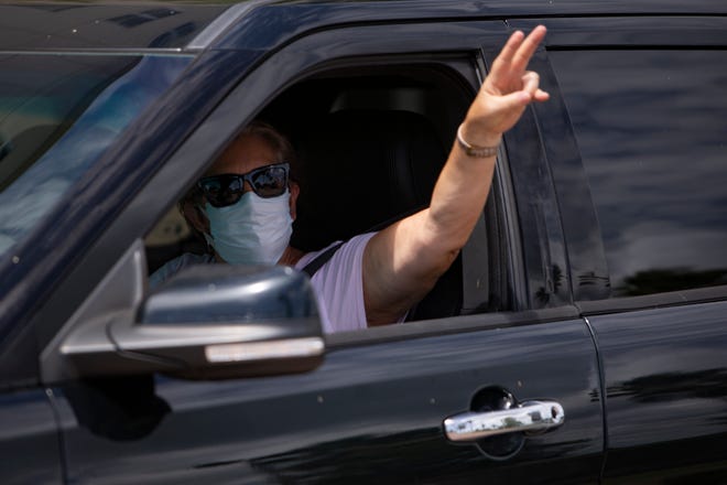 Demonstrators drive past the Collier County Public Schools Dr. Martin Luther King, Jr. Administrative Center offices in North Naples on Monday, July 27, 2020, to shed light on their fears of reopening schools this fall.