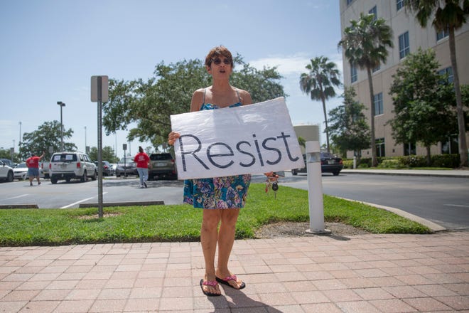 Cynthia Odierna, a teacher at Naples High School, protests against reopening schools this fall, Monday, July 27, 2020,  in front of the Collier County Public Schools Dr. Martin Luther King, Jr. Administrative Center offices in North Naples.