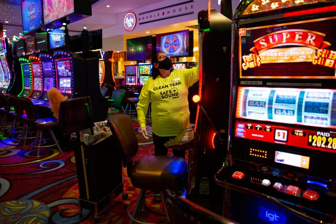Floor attendant Maria Hernandez disinfects gaming machines, Thursday, Aug. 27, 2020, at Seminole Casino Hotel in Immokalee.