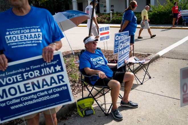 Volunteers campaign for their candidates during primary election day outside of precinct 251 at the Collier County library headquarters in Naples on Tuesday, August 18, 2020.