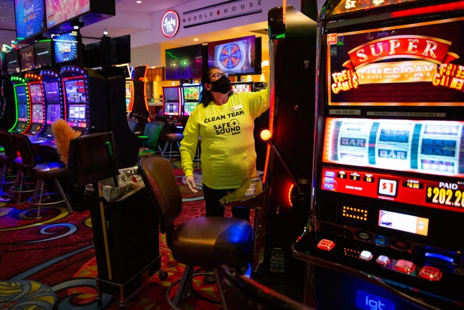 Floor attendant Maria Hernandez wipes down a gaming machine at Seminole Casino Hotel in Immokalee on Thursday, Aug. 27, 2020.