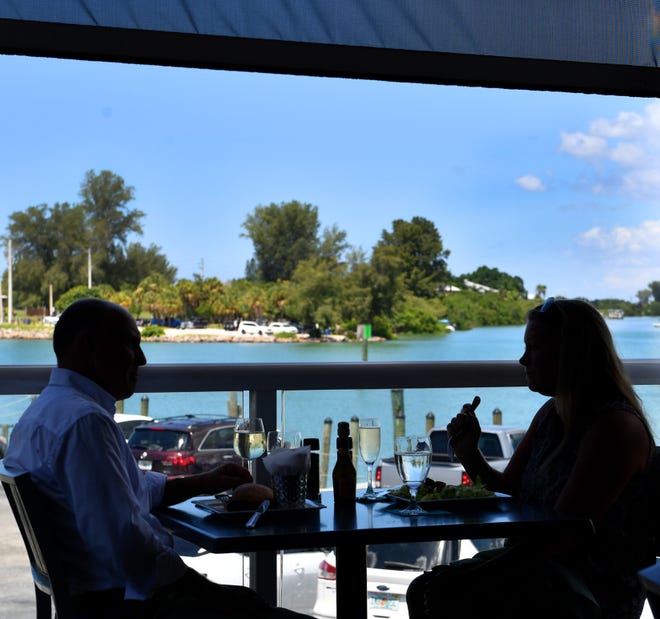 The Crow’s Nest Restaurant & Marina offers an outdoor dining area with a view of the Venice Inlet.