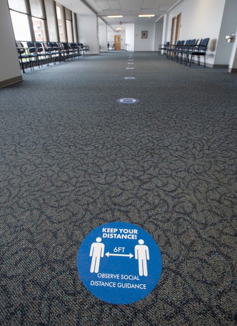 Social distancing markers line the floor at the Escambia County Courthouse in downtown Pensacola on Friday, Sept. 11, 2020.  The courthouse that has had limited access due to the COVID-19 pandemic is preparing to resume jury trials soon.