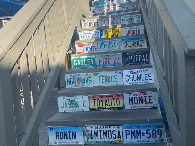 The stairs leading to Snook Inn's observation deck are lined in license plates from around the U.S.