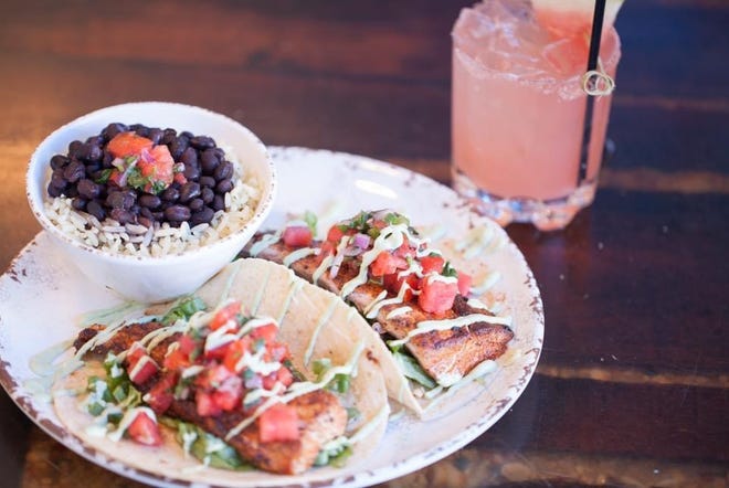 Blackened mahi tacos with rice, beans and a tropical cocktail from Snook Inn on Marco Island.