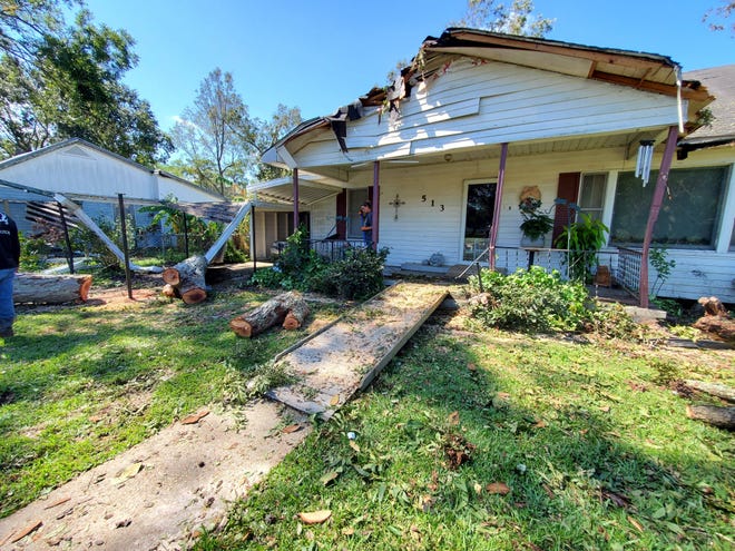 Hurricane Delta knocked down a tree, damaging the house of an 89-year-old woman in Abbeville, Louisiana on Oct. 10, 2020.