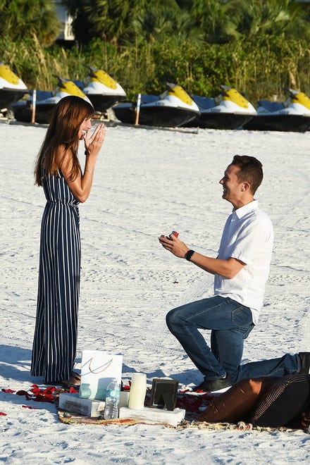 Brent Fallows goes down on one knee to pop the question fo Elana Bandalene. The couple came from Chicago to Marco Island, with longstanding family associations, for a surprise proposal on the beach at sunset.