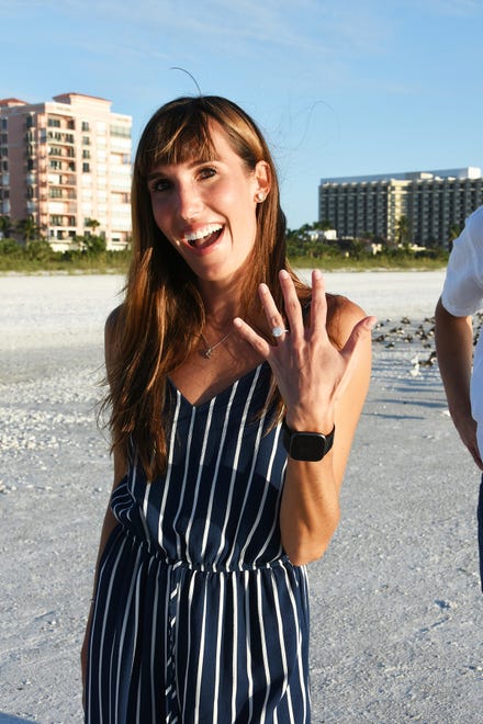 Elana Bandalene shows off her ring. The couple came from Chicago to Marco Island, with longstanding family associations, for a surprise proposal on the beach at sunset.