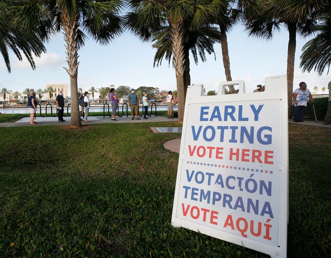 Residents line up City Island in Daytona Beach, Florida to cast their vote as early voting begins, Monday, Oct. 19, 2020. See more photos .