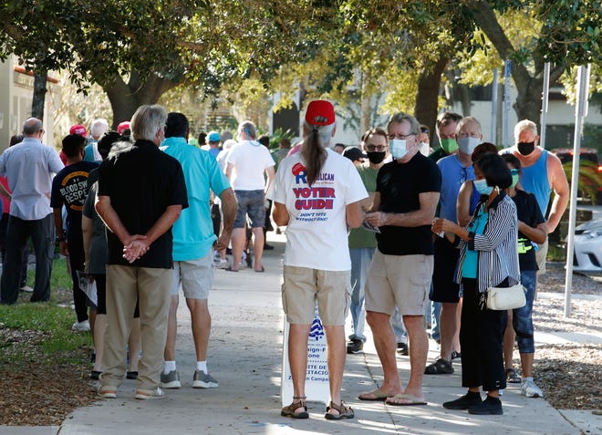Voters line up at Ormond Beach Regional Library to cast their vote as early voting begins, Monday, Oct. 19, 2020.