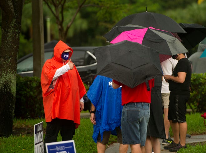 People line up to vote at the Lantana Road Branch Library during the first day of in-person early voting in Palm Beach County at Monday October 19, 2020 in Lake Worth.  [MEGHAN MCCARTHY/palmbeachpost.com]