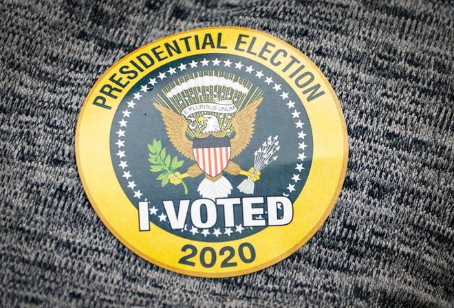 A voters sticker after voting on the first day of in person early voting at the Jupiter Community Center in Jupiter, Florida on October 19, 2020. (GREG LOVETT / THE PALM BEACH POST)