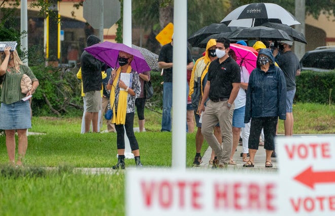 Voters wait in line to cast their ballots on the first day of in person early voting at the Jupiter Community Center in Jupiter, Florida on October 19, 2020. (GREG LOVETT / THE PALM BEACH POST)