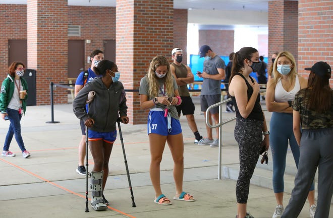Residents wait in line to early vote in the 2020 Presidential Election at the Reitz Union on the University of Florida campus, in Gainesville Fla., Oct. 19, 2020. Alachua County has six early voting locations that are open daily 9am to 6pm.