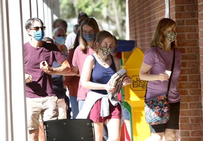 Residents wait in line to early vote in the 2020 Presidential Election at the Millhopper Branch of the Alachua County Library, in Gainesville Fla., Oct. 19, 2020. Alachua County has six early voting locations that are open daily 9am to 6pm.