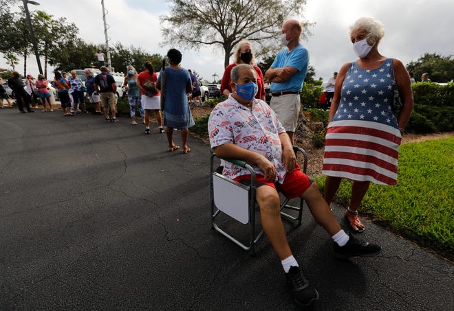 Residents wait in long lines as early in-person voting started Monday, Oct. 19 in Cape Coral, Florida. The Cape Coral library is one of several locations where registered voters can participate. It will be open from 10 a.m. - 5 p.m. See more photos .