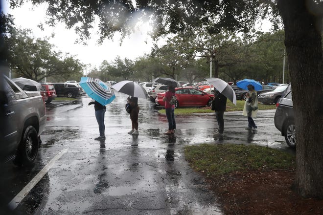 The East County Regional Library and Veterans Park in Lehigh Acres had long lines of early voters on Monday, October 19, 2020. Voters at the library braved a steady down pour.