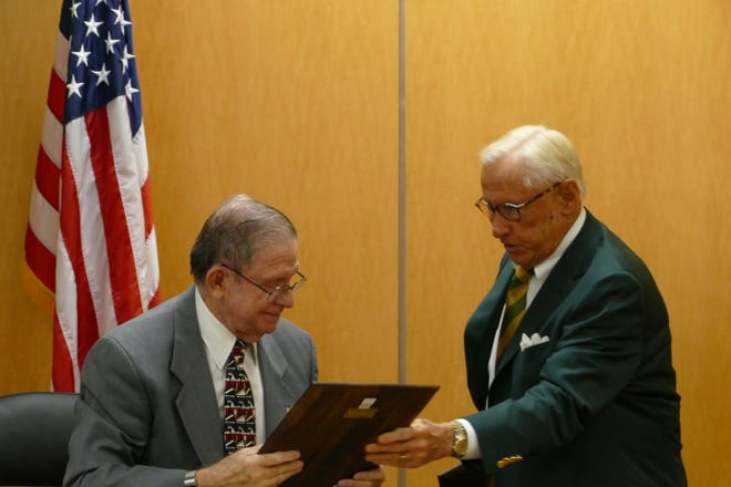 Marco Island City Council chairman Erik Brechnitz, left, hands in a plaque to Councilor Victor Rios on Oct. 19, 2020.