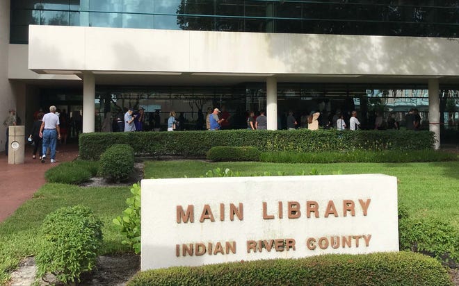 Voters wrap around the building of the Indian River County Main Library on the first day of early voting Monday, Oct. 19, 2020, in Vero Beach. Some voters said they waited an hour to get inside to vote.