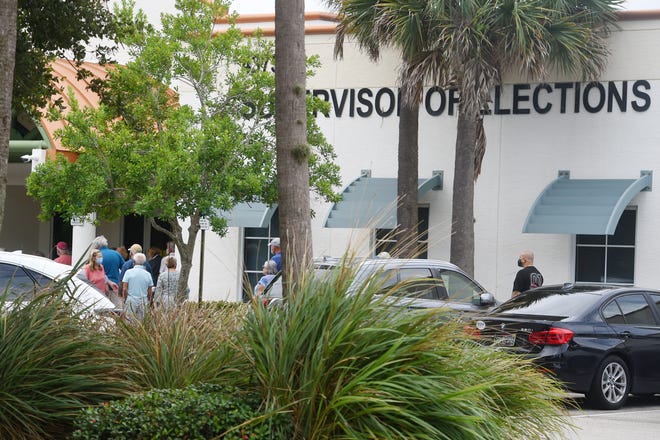A line begins to form around the outside wall of the Indian River County Supervisor of Elections office on Monday, Oct. 19, 2020, as community members gather on the first day of early voting in Vero Beach.