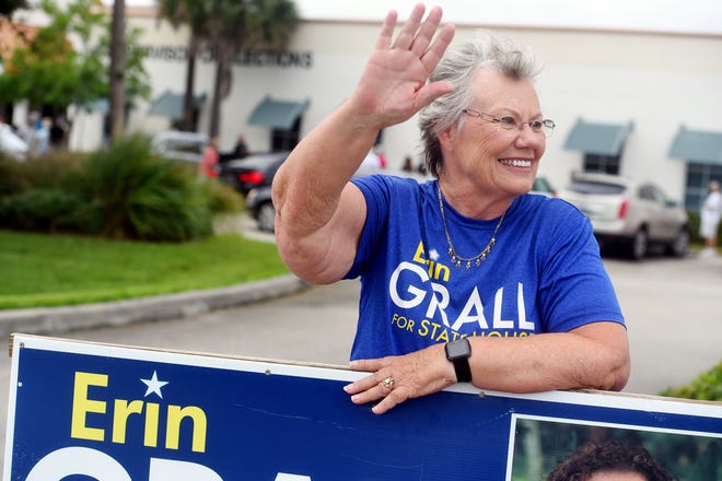 Marge Grall, mother of Erin Grall, running for State Representative District 54, waves to passing motorists in front of the Indian River County Supervisor of Elections office on Monday, Oct. 19, 2020, on the first day of early voting in Vero Beach.