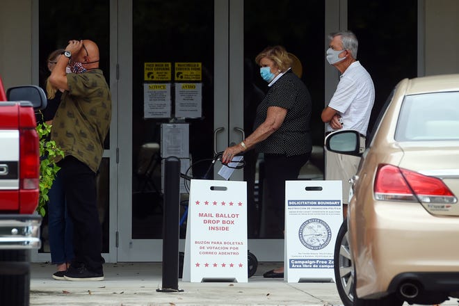 A line begins to form around the outside wall of the Indian River County Supervisor of Elections office on Monday, Oct. 19, 2020, as community members gather on the first day of early voting in Vero Beach.