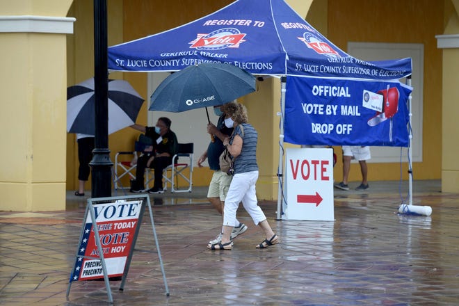 Ralph and Marie Bernabei, of Port St. Lucie, exit the MidFlorida Event Center after casting a ballot on the first day of early voting, Monday, Oct. 19, 2020, in Port St. Lucie. "It's important, everybody should come out and vote. Don't miss it," said Ralph Bernabei. Rain in the early afternoon resulted in a zigzag line inside the event center, with some voters waiting 90 minutes or more to cast their ballot.