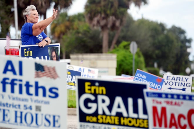 Marge Grall, mother of Erin Grall, running for State Representative District 54, waves to passing motorists in front of the Indian River County Supervisor of Elections office on Monday, Oct. 19, 2020, on the first day of early voting in Vero Beach.