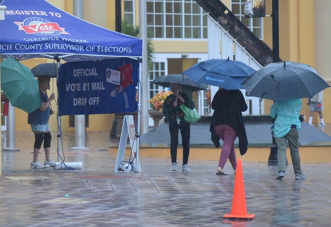 Voters make their way in and out of the MidFlorida Event Center to cast their a ballots on the first day of early voting, Monday, Oct. 19, 2020 in Port St. Lucie.