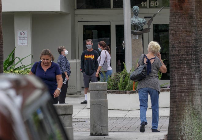 A steady flow of voters are seen at the Hoke Library, casting their ballots on the first day of early voting, on Monday, Oct. 19, 2020, in Jensen Beach.