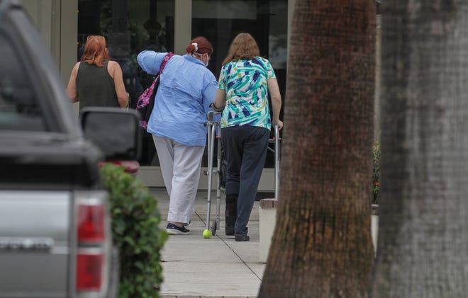 A steady flow of voters are seen at the Hoke Library, casting their ballots on the first day of early voting, on Monday, Oct. 19, 2020, in Jensen Beach.