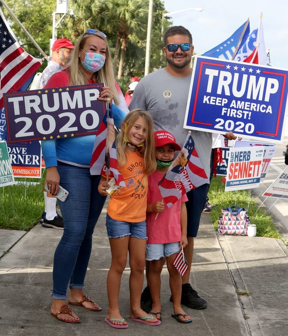 The Soler famil from West Palm Beach await the arrival of President Trump, outside of the early voting polling station located at The Palm Beach County Library, 3650 Summit Blvd. West Palm Beach.