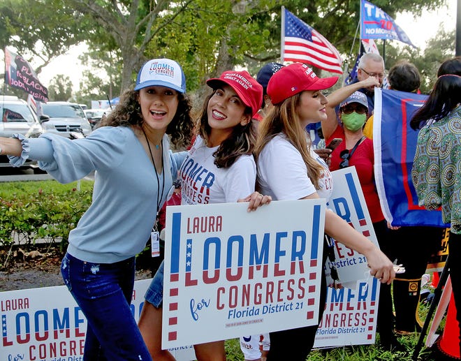 Laura Loomer campain staff, Stephanie Aszkenas, Heydi Martinez, and Alex Amor excite voters as they await the arrival of President Trump, outside of the early voting polling station located at The Palm Beach County Library, 3650 Summit Blvd. West Palm Beach.