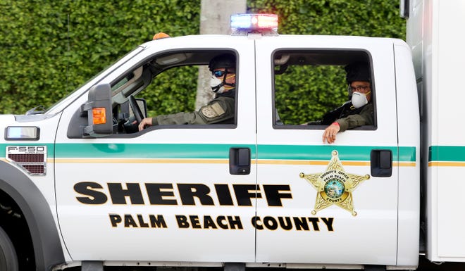 Palm Beach County Sheriff Deputies patrol Summit Boulevard as voters await the arrival of President Trump, outside of the early voting polling station located at The Palm Beach County Library, 3650 Summit Blvd. West Palm Beach.