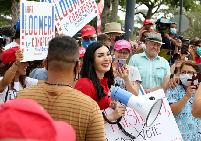 Laura Loomer addresses the crowd of voters as they wait to cast their votes and maybe a glimpse of President Trump as he arrives at the early voting polling station located at The Palm Beach County Library on Summit Blvd. in West Palm Beach where he too submitted his vote.