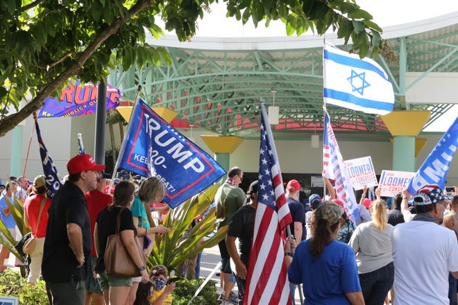 Voters await the arrival of President Trump, outside of the early voting polling station located at The Palm Beach County Library, 3650 Summit Blvd. West Palm Beach.