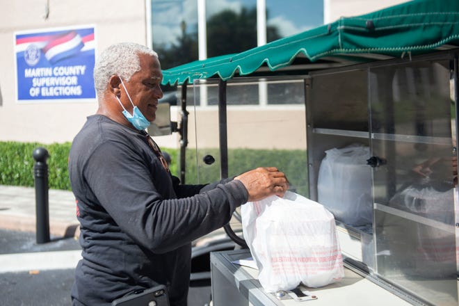 Jimmy Smith, president of the NAACP of Martin County and owner of Jimmy Smith BBQ, delivers meals to the Martin County Supervisor of Elections office Saturday, Oct. 24, 2020, in Stuart. As part of the Souls to the Polls rally and voting drive, Smith led a group to vote earlier in the day. "We educate people on the power of their vote," Smith said of the event. "That's when we start to see things change in America."