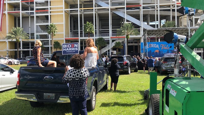 Supporters in -- and on -- their vehicles wait for President Barack Obama to speak at a Joe Biden campaign rally in Orlando Tuesday, Oct. 27, 2020.