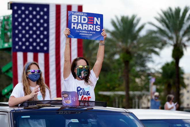 Supporters cheer as former President Barack Obama speaks at a rally as he campaigns for Democratic presidential candidate former Vice President Joe Biden Tuesday, Oct. 27, 2020, in Orlando, Fla.