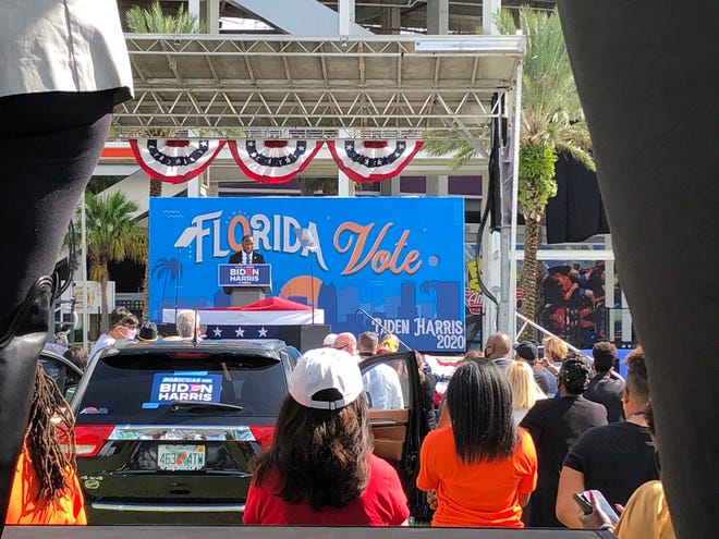 Supporters in -- and on -- their vehicles wait for President Barack Obama to speak at a Joe Biden campaign rally in Orlando Tuesday, Oct. 27, 2020.