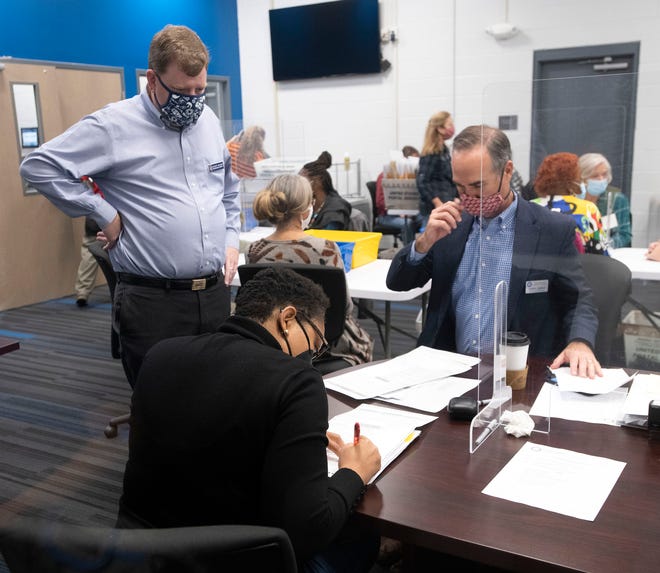 Escambia County Commissioner Robert Bender looks on as Supervisor of Election David Stafford and County Judge Kierra Smith review ballots during a meeting of the Canvassing Board on Friday, Oct. 30, 2020.