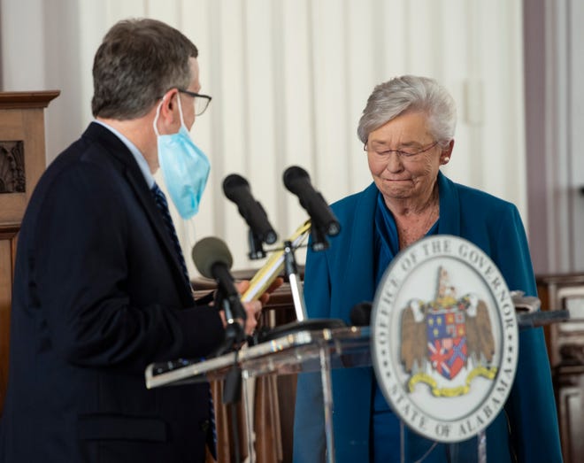 Gov. Kay Ivey acknowledges Alabama Health Officer Dr. Scott Harris during a press conference update on Covid-19 restrictions at the Alabama State Capitol in Montgomery, Ala., on Thursday, Nov. 5, 2020.