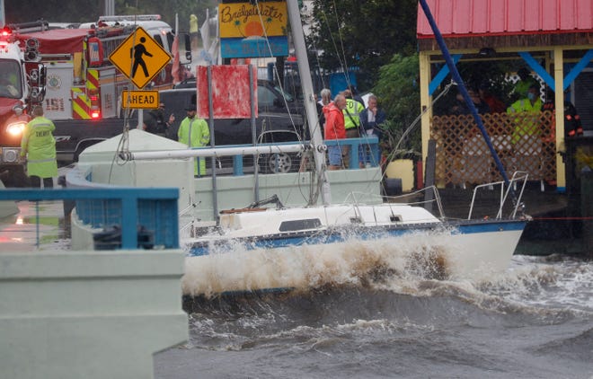 The strong winds from Hurricane EtaÊdragged a live-aboard sailboat under the Matlacha Bridge Wednesday, Nov, 11, 2020 forcing the bridge to close temporarily.